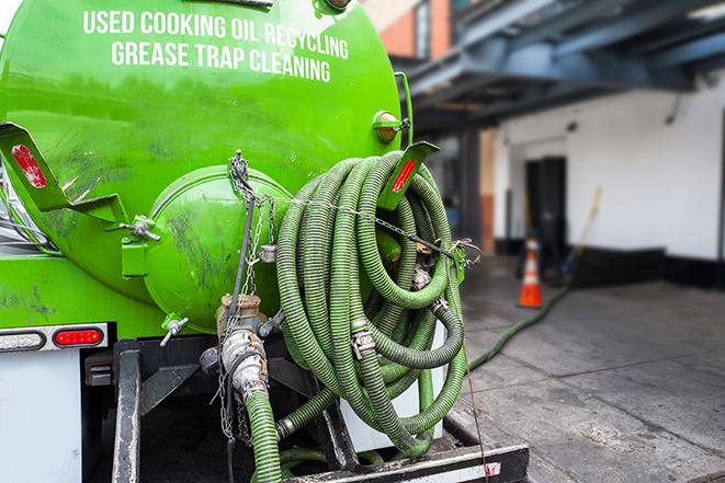 large truck pumping grease trap at a restaurant in Arnold